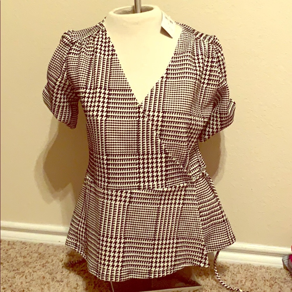 A New Classic Fashion Nova plaid peplum top.